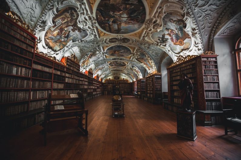 Shelving Units - photo of library with religious embossed ceiling