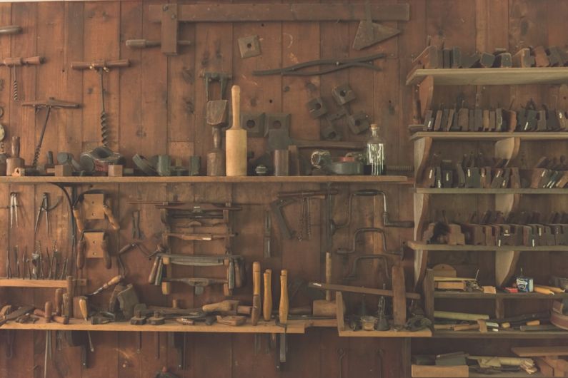 Garage Shelves - assorted hand tool lot on brown wooden shelf