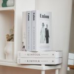 Shelving Units - a couple of books sitting on top of a white shelf