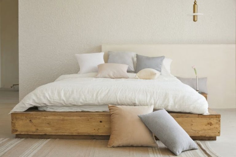 Minimalist Decor - white bed pillow on brown wooden bed frame