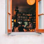 Open Shelves - window of wine bar with people