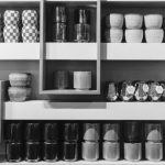 Bathroom Shelves - a shelf filled with lots of different types of cups