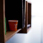 Shelving Solutions - red disposable cup on brown wooden shelf
