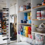 Garage Shelves - person taking photo of paint containers on display rack